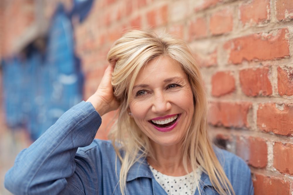 Laughing,Vivacious,Middle-aged,Woman,Mussing,Her,Long,Blond,Hair,With