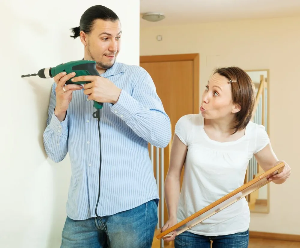 Middle-aged,Man,And,Woman,Hanging,Art,Picture,At,Home