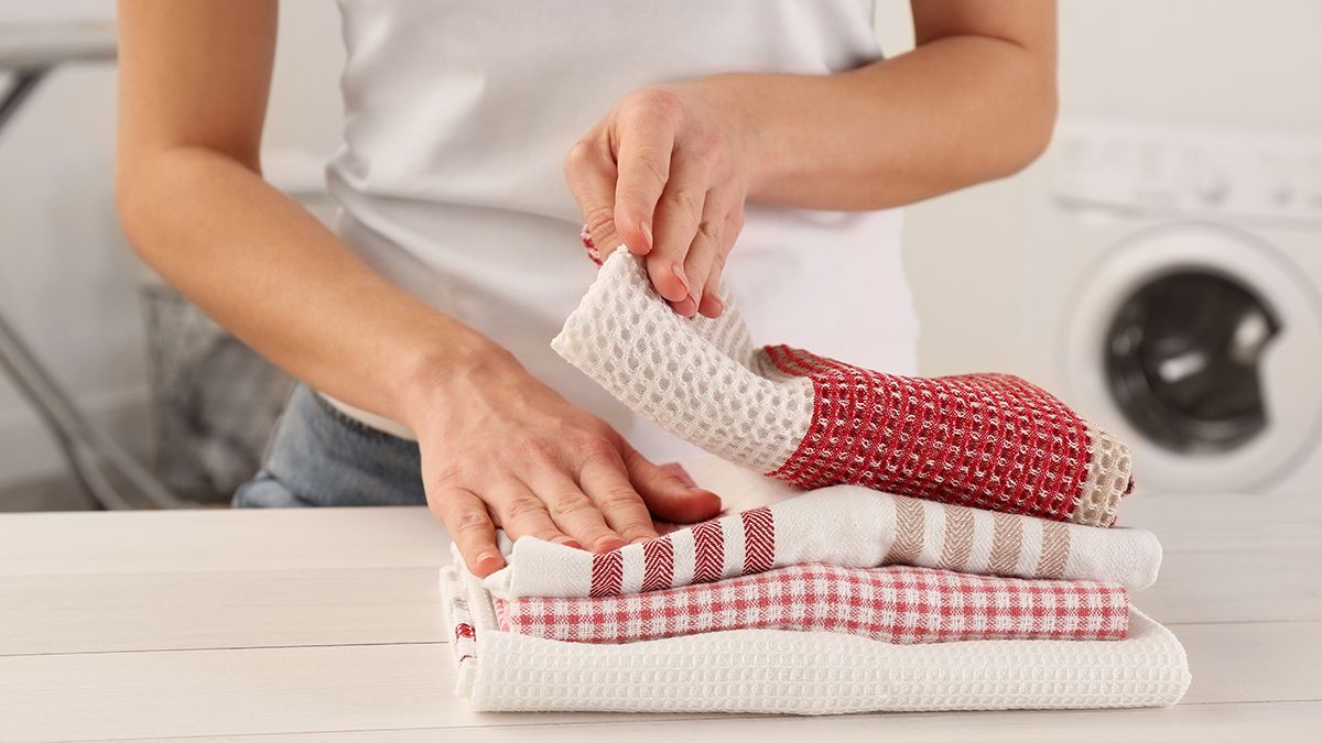 Woman,With,Clean,Kitchen,Towels,At,White,Wooden,Table,In