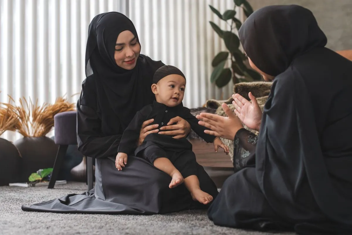 Happy,Muslim,Family,,Muslim,Boy,Sitting,On,Woman's,Lap,And