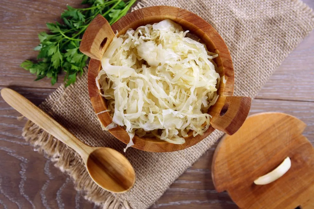 Sauerkraut,In,A,Wooden,Barrel,On,Brown,Table