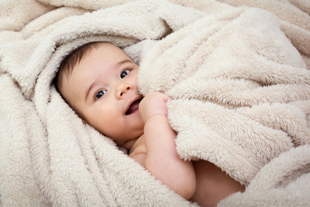 Cute,Baby,Boy,In,Bed,Under,A,Fluffy,Blanket