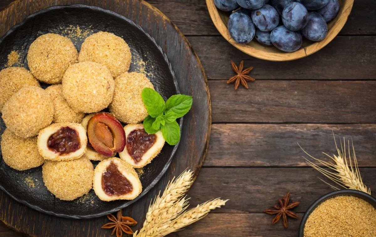 Plum,Dumplings,With,Brown,Suggar,On,The,Wooden,Table