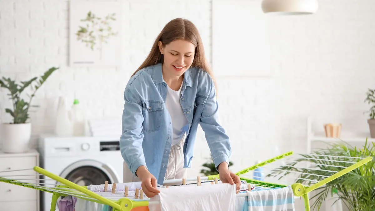 Woman,Hanging,Clean,Clothes,On,Dryer,In,Laundry,Room