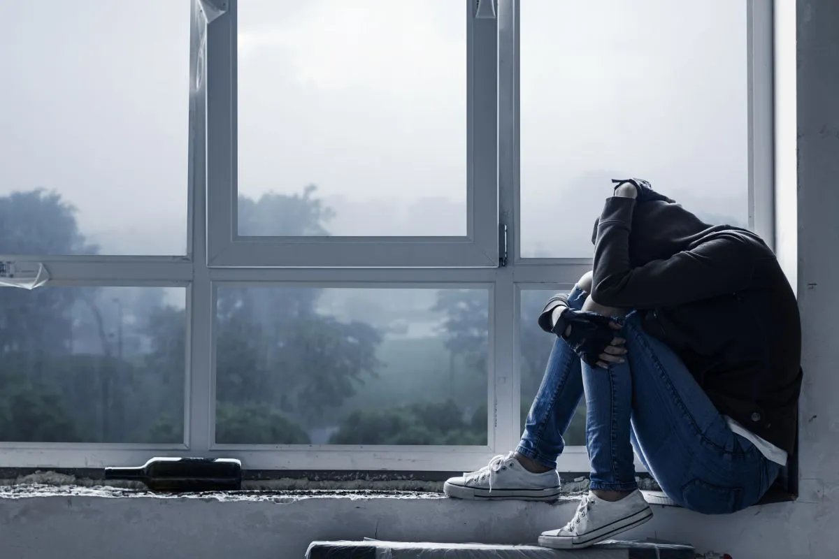 Lonely,,Depressed,,Upset,Young,Woman,In,Hood,Is,Sitting,On