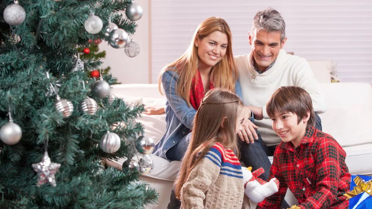 Brother,And,Sister,Exchanging,Christmas,Gifts,In,Front,Of,Their
