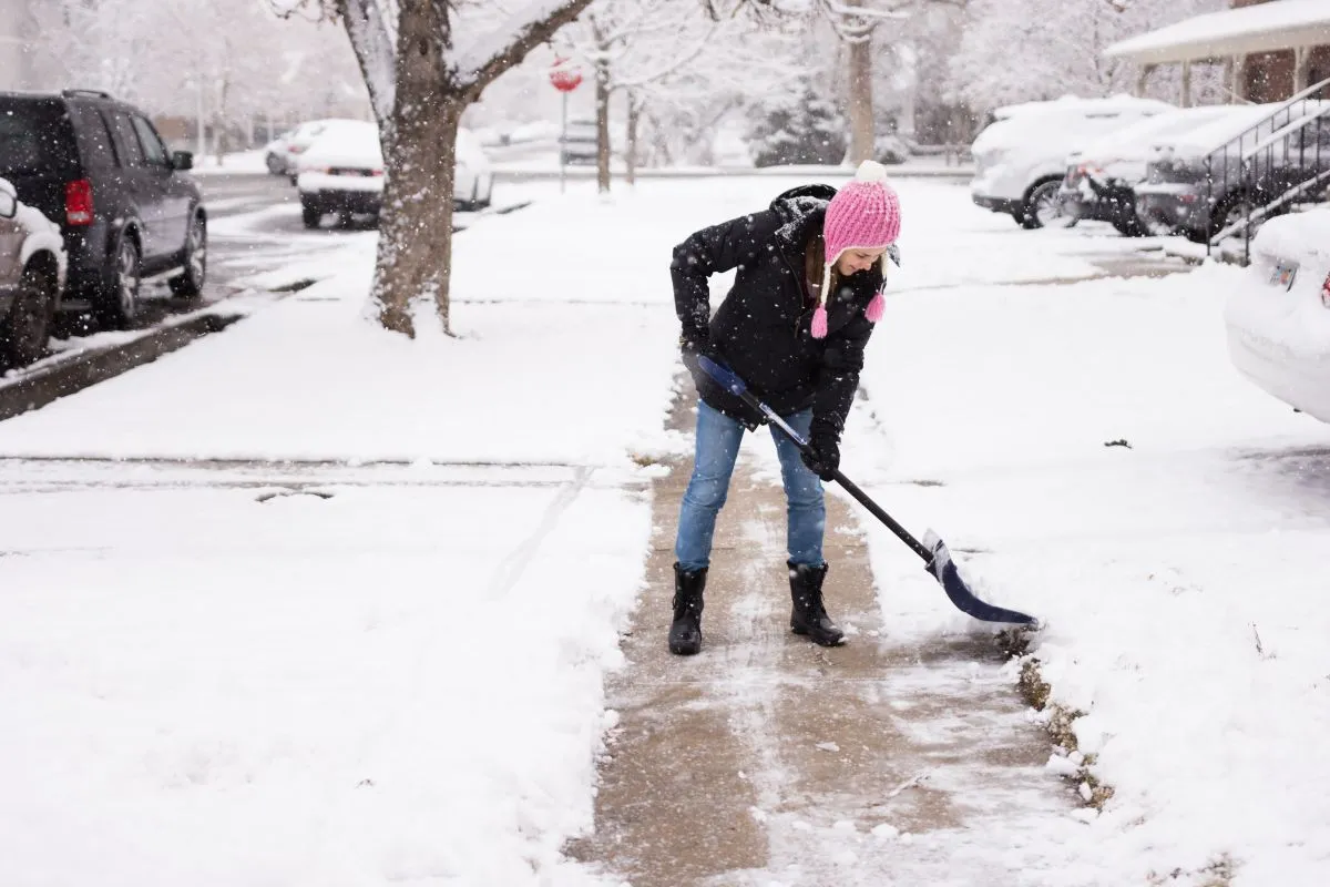 Woman,In,Cute,Pink,Hat,Shovelling,/,Shoveling,Snow