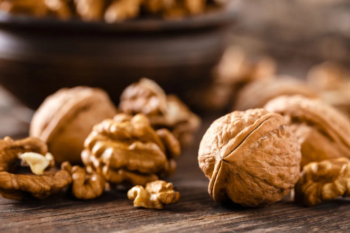 Walnuts.,Kernels,And,Whole,Nuts,On,Wooden,Rustic,Table