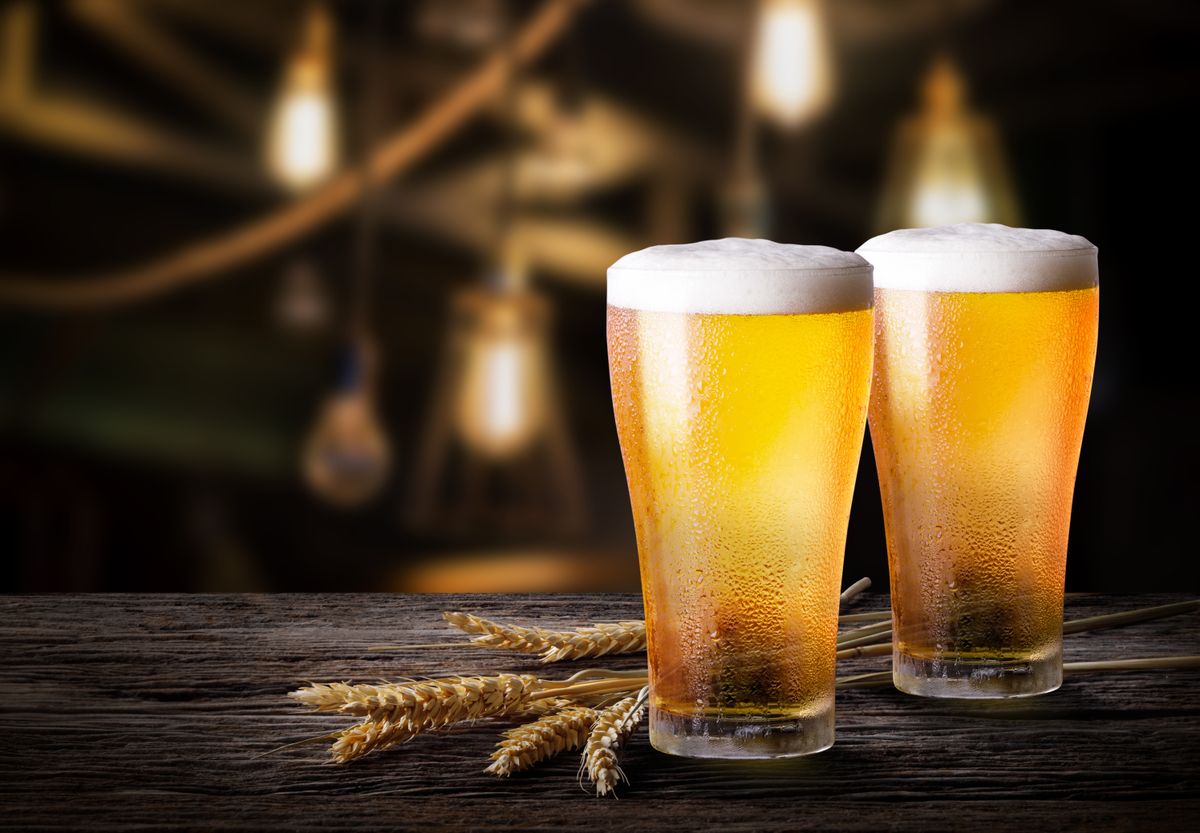 Two,Glass,Of,Beer,With,Wheat,On,Wooden,Table
