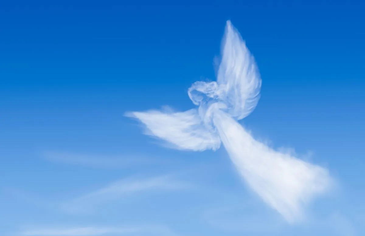 Angel,Flying,In,The,Sky.,Angel-shaped,Cloud