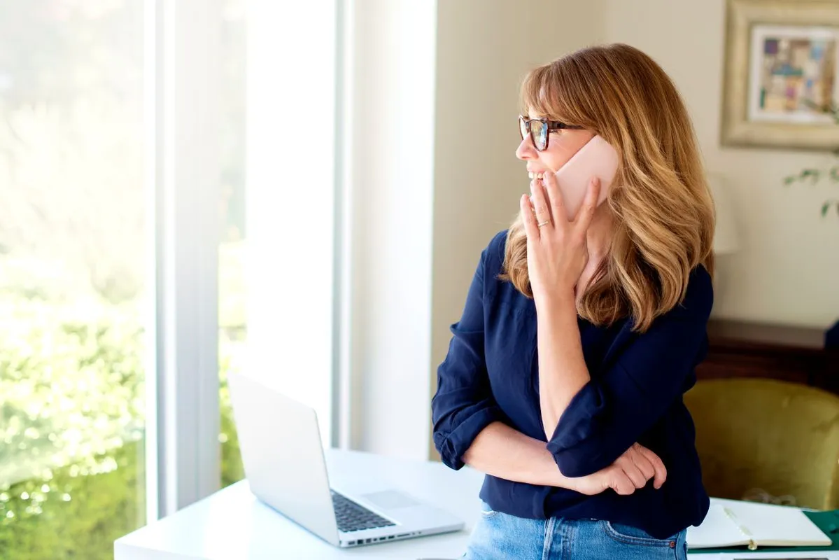 Portrait,Of,Middle,Aged,Woman,Using,Mobile,Phone,And,Making