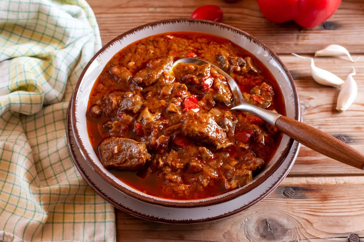Pork,Goulash,Meat,With,Dumplings,On,Plate,,Cutlery,,Garlic,,Onion,