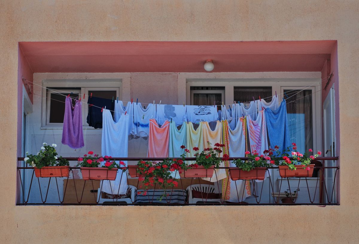 Laundry,Drying,On,The,Balcony,Of,A,Building