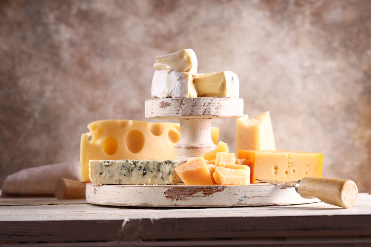 Assortment,Of,Cheese,,Camembert,And,Parmesan,On,Wooden,Background