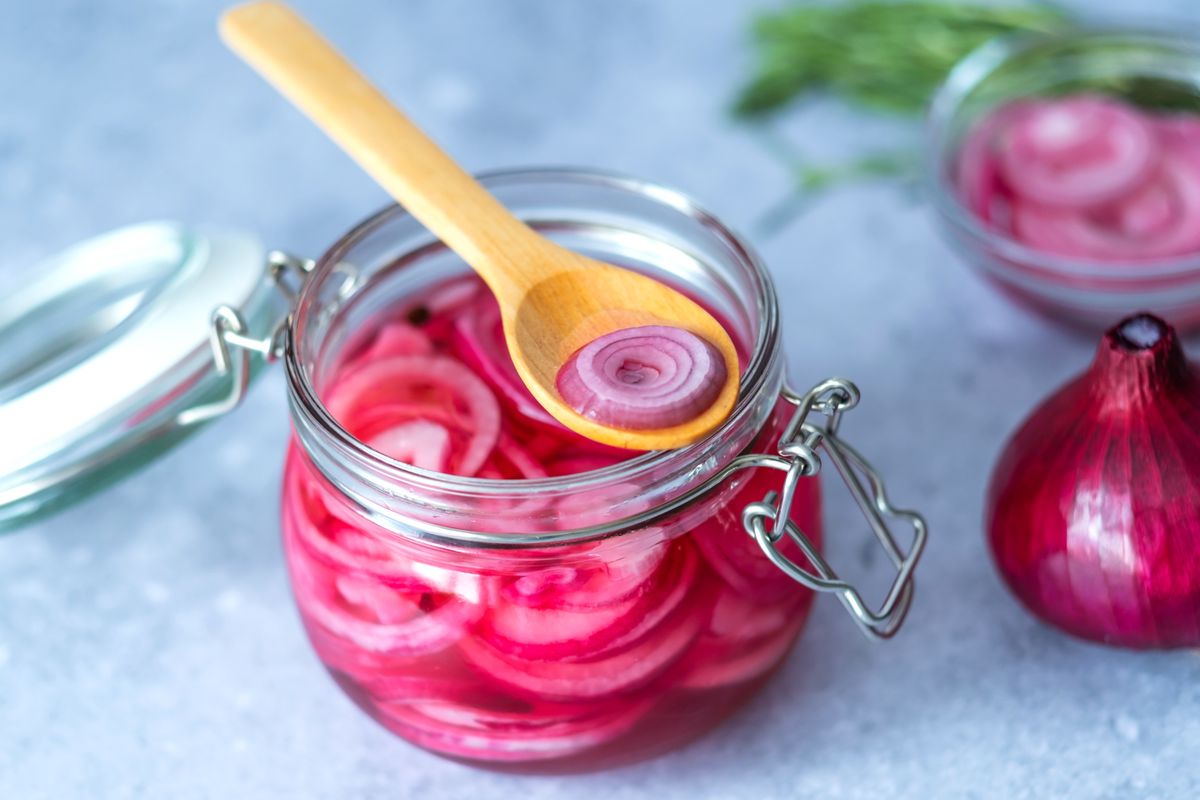 Pickled,Red,Onion,Rings,On,A,Wooden,Spoon,On,A