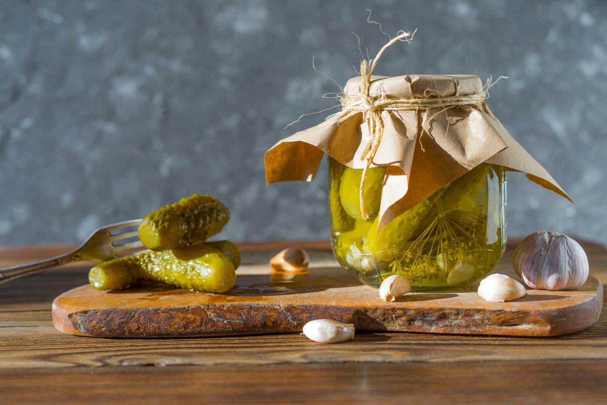 Homemade,Jars,Of,Pickled,Cucumbers,With,Garlic,On,A,Rustic