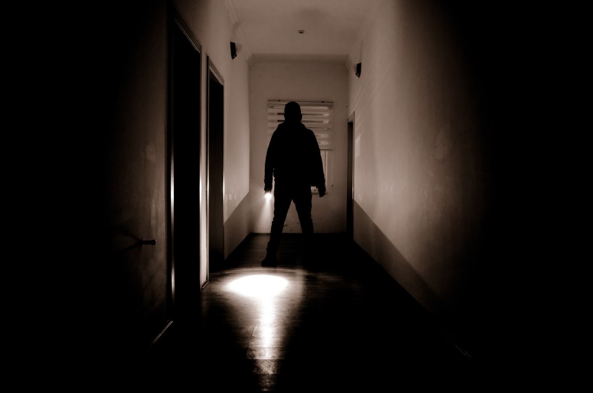 Dark,Corridor,With,Cabinet,Doors,And,Lights,With,Silhouette,Of