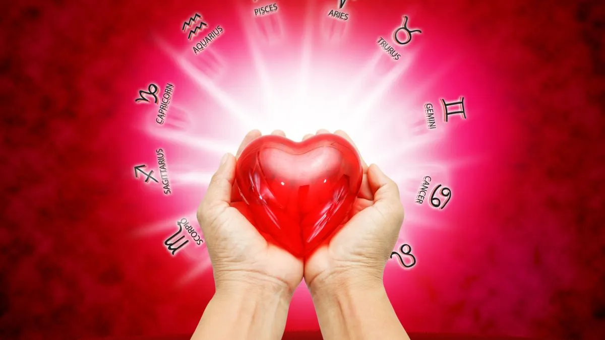 Hand,Holding,Red,Heart,On,Zodiac,Background,.