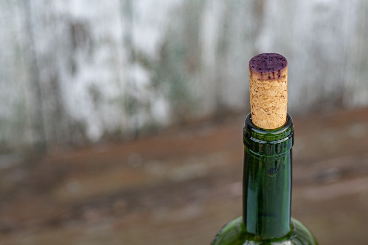 Closeup,Of,Wine,Bottleneck,Closed,With,Cork,Stopper,Stained,By