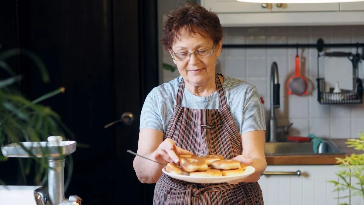 Portrait,Of,An,Active,Elderly,Woman,Cooking,In,The,Kitchen.