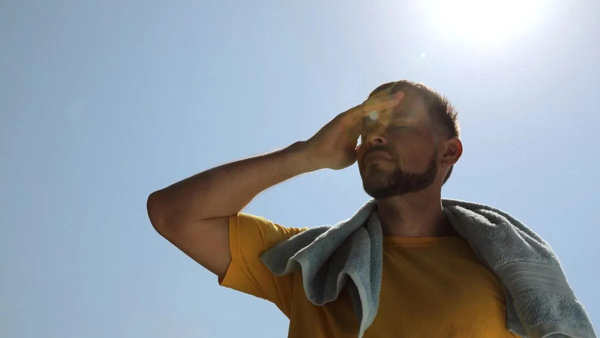 Man,With,Towel,Suffering,From,Heat,Stroke,Outdoors
