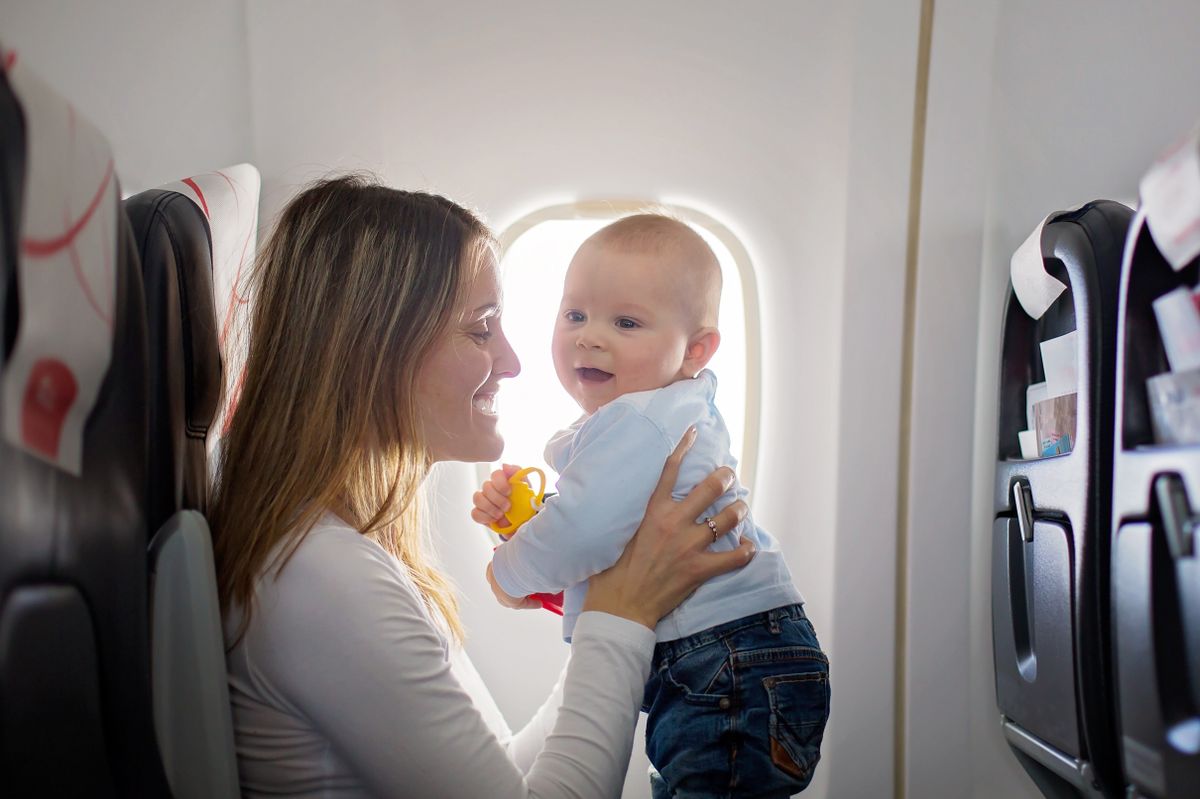 Young,Mom,,Playing,And,Breastfeeding,Her,Toddler,Boy,On,Board