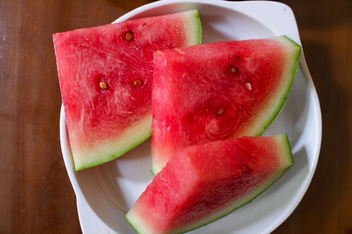 Red,Watermelon,Cut,Into,Triangles,,On,A,White,Plate,,Stock