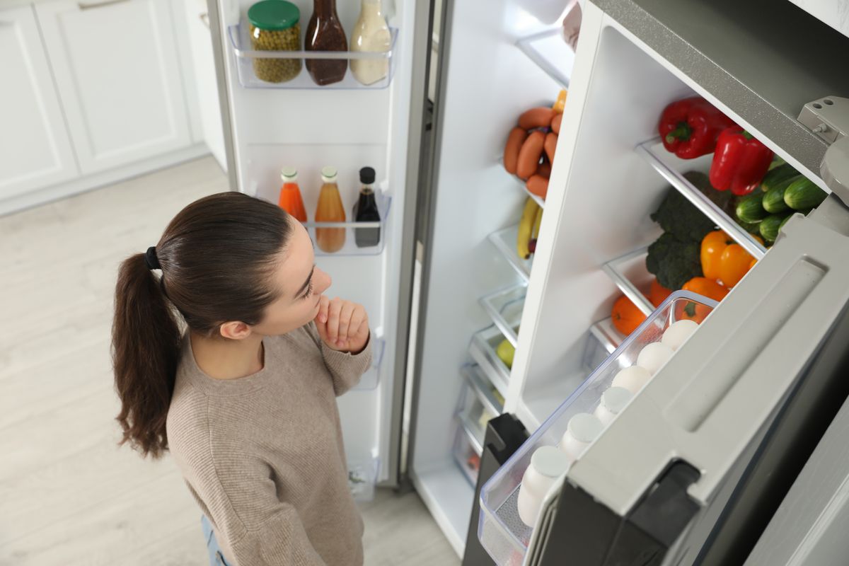 Young,Woman,Near,Open,Refrigerator,Indoors,,Above,View