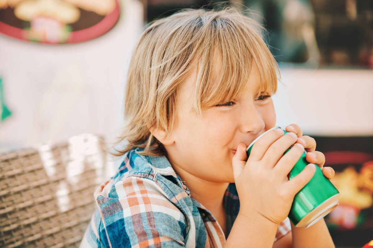 Little,Kid,Boy,Drinking,Soda,In,Cafe,On,A,Very