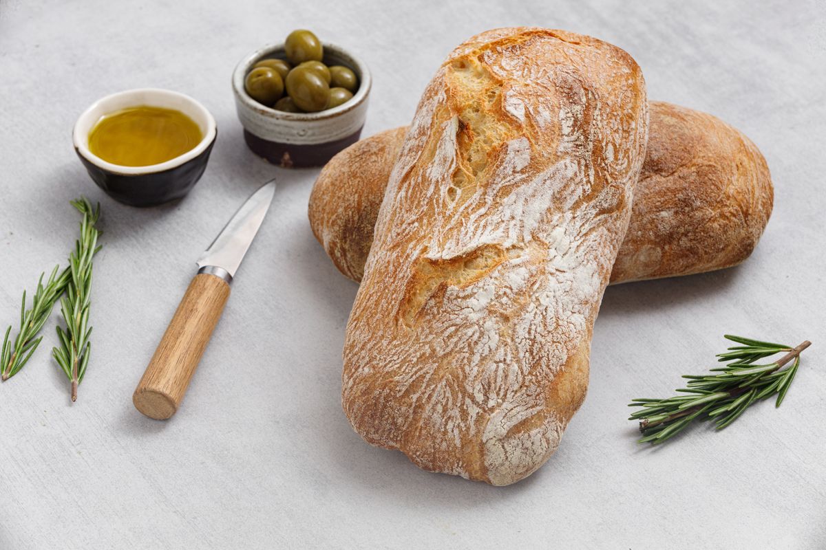 Artisan,Sourdough,Ciabatta,Bread,With,Olives,And,Rosemary,On,A