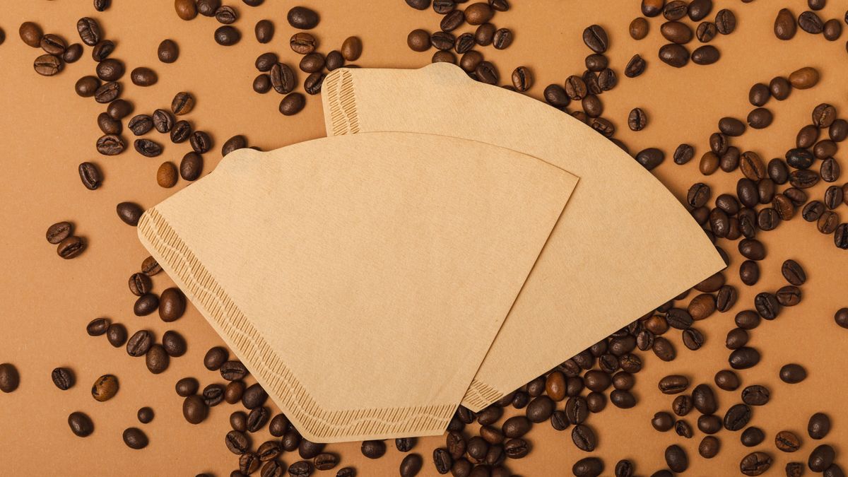 Coffee,Filter,With,Ground,Powder,On,A,Brown,Background.,Fragrant