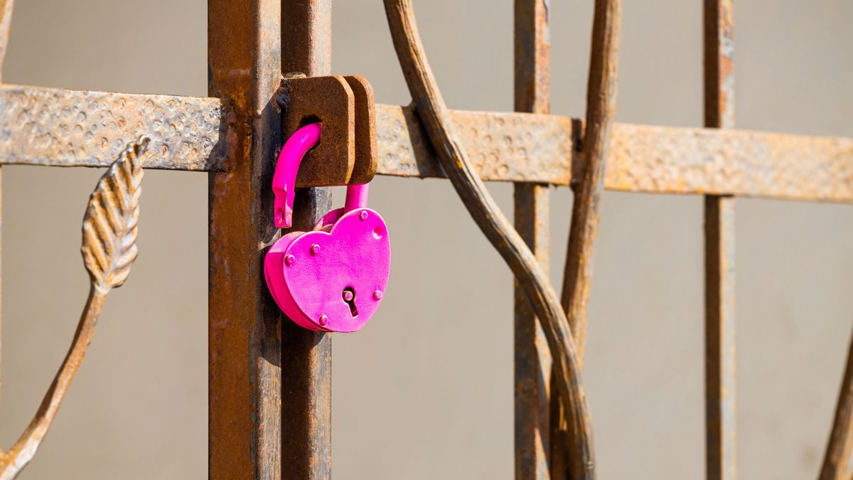 A,Heart-shaped,Padlock,Hanging,On,A,Metal,Gate.,Open,Padlock.