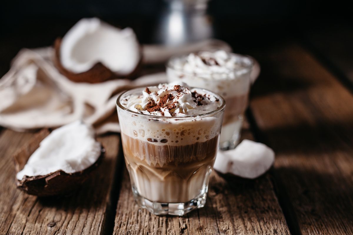 Coconut,Latte,On,A,Wooden,Table.,Broken,Coconut.,Low,Key