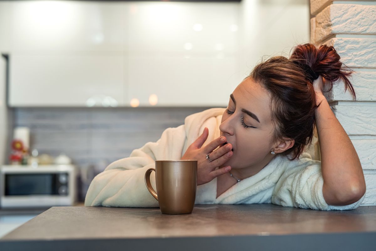 Beautiful,Young,Girl,In,A,White,Coat,And,Sneakers,Sleepy