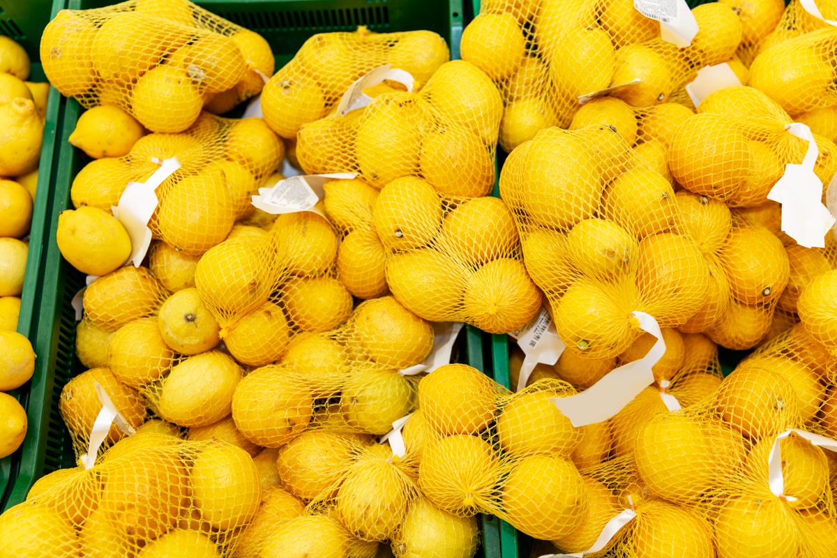 Fresh,Lemons,In,Factory,Nets,On,The,Counter,In,The