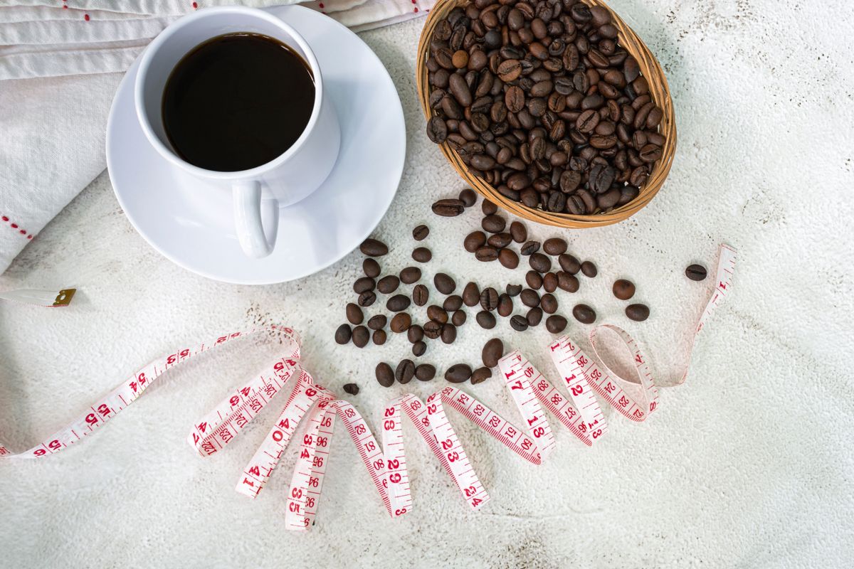 Cup,Of,Coffee,And,Coffee,Beans,Background,With,Measure,Tap