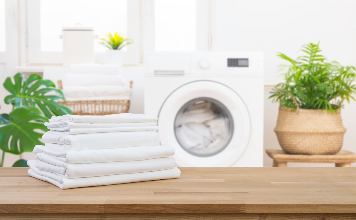 Stack,Of,Clean,Folded,Laundry,Bedding,Sheets,On,Wooden,Table