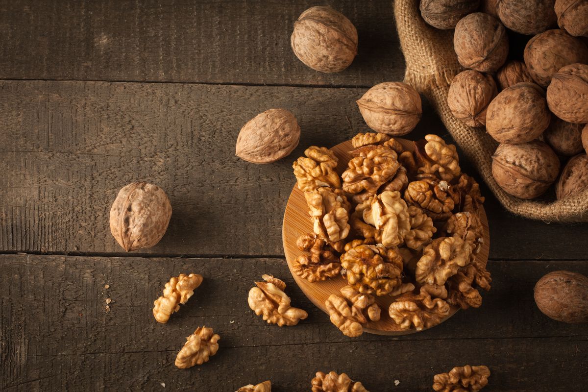 Walnut,Kernels,In,Sack,And,Whole,Walnuts,On,Rustic,Old