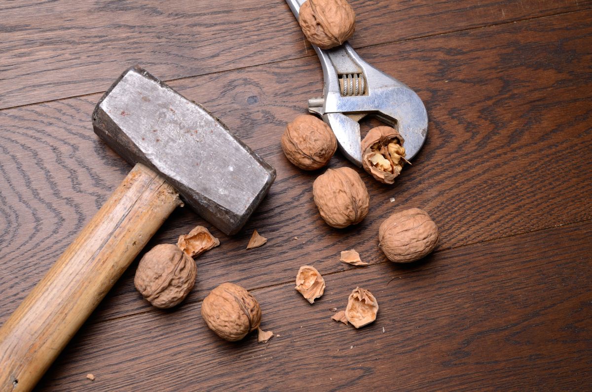 Cracked,Walnuts,With,A,Big,Hammer,And,An,Old,Wrench