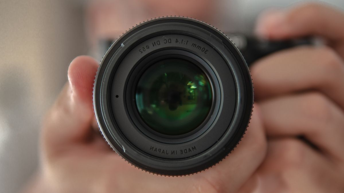 Holding,A,Lens,Close-up