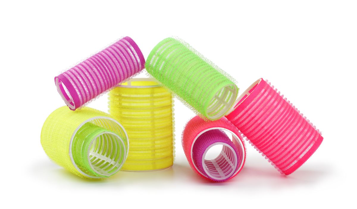 A,Stack,Of,Yellow,Hair,Rollers,Isolated,On,A,White