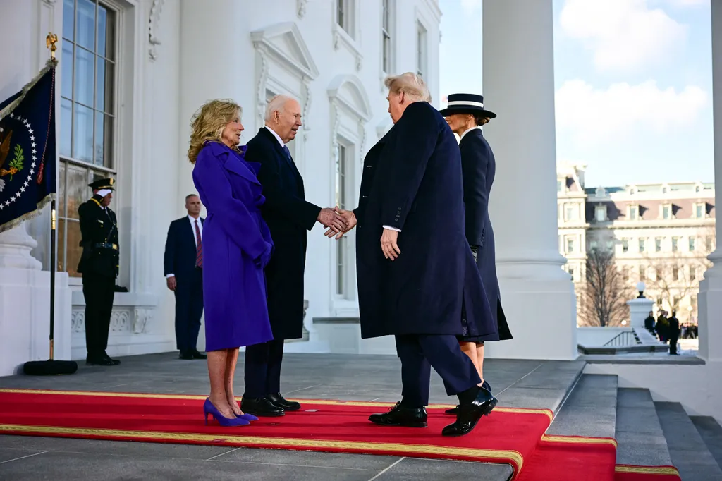 US President Joe Biden and First Lady Jill Biden greet President-elect Donald Trump and Melania Trump as they arrive at the White House in Washington, DC, on January 20, 2025, before departing for the US Capitol where Trump will be sworn in as the 47th US President. (Photo by Jim WATSON / AFP)