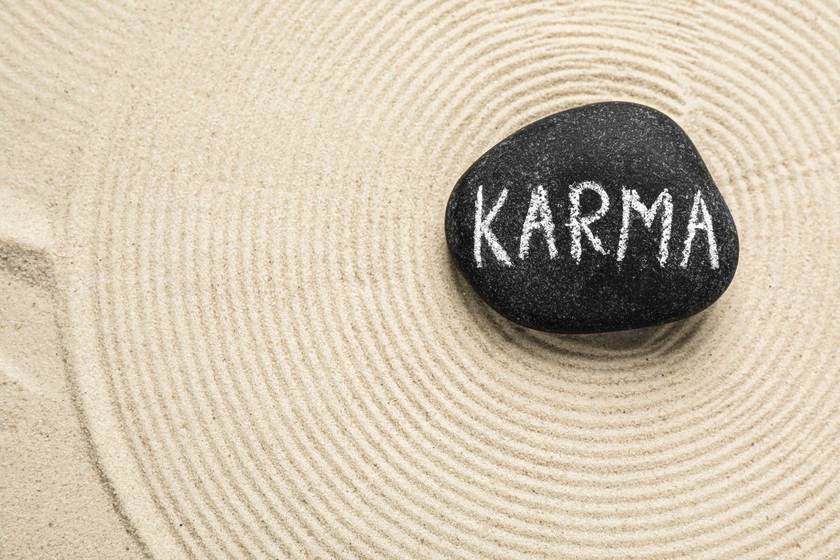 Karma Stone,With,Word,Karma,And,Circles,On,Sand,,Top,View.