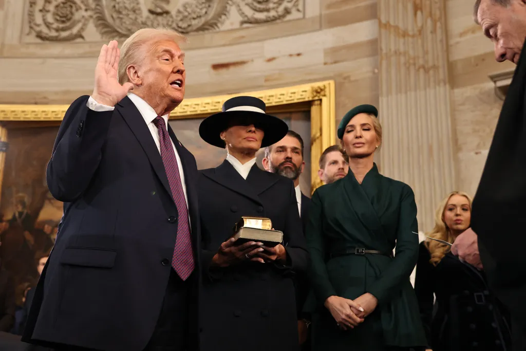 US President-elect Donald Trump takes the oath of office from US Supreme Court Chief Justice John Roberts as Melania Trump and daghter Ivanka look on during inauguration ceremonies in the Rotunda of the US Capitol on January 20, 2025 in Washington, DC. Donald Trump takes office for his second term as the 47th president of the United States. (Photo by Chip Somodevilla / POOL / AFP)