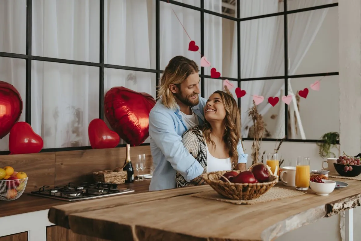 Happy,Young,Couple,Embracing,While,Celebrating,Valentines,Day,With,Red