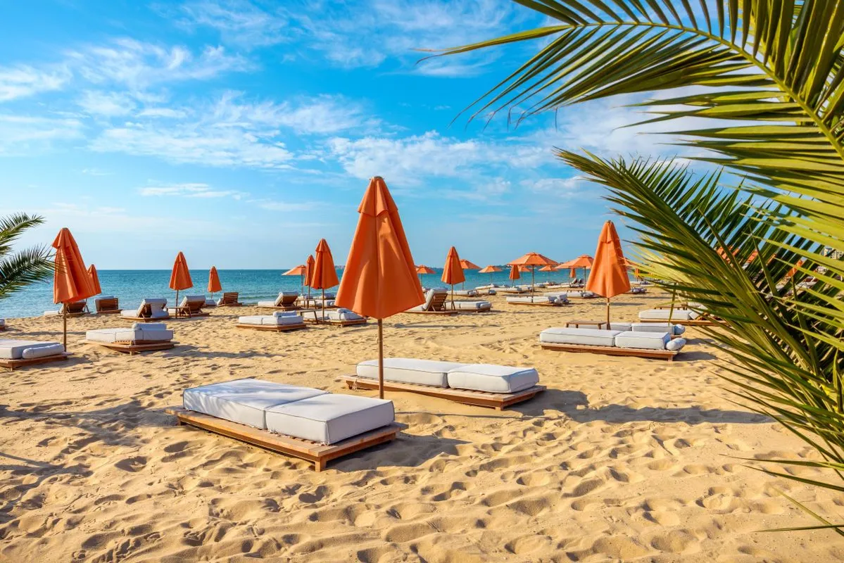 Beach,Deckchairs,With,Orange,Umbrellas,At,Sunny,Beach.,Bulgaria