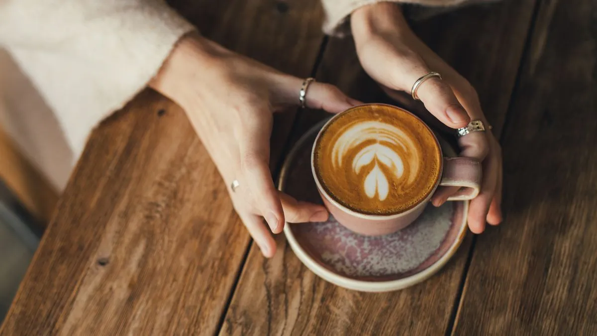 Woman,Drinking,Coffee,Sitting,By,The,Textured,Wooden,Table.,Close