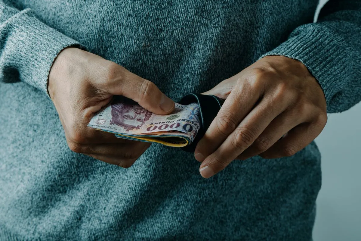 Closeup,Of,A,Man,,Wearing,A,Gray,Pullover,,Taking,Out