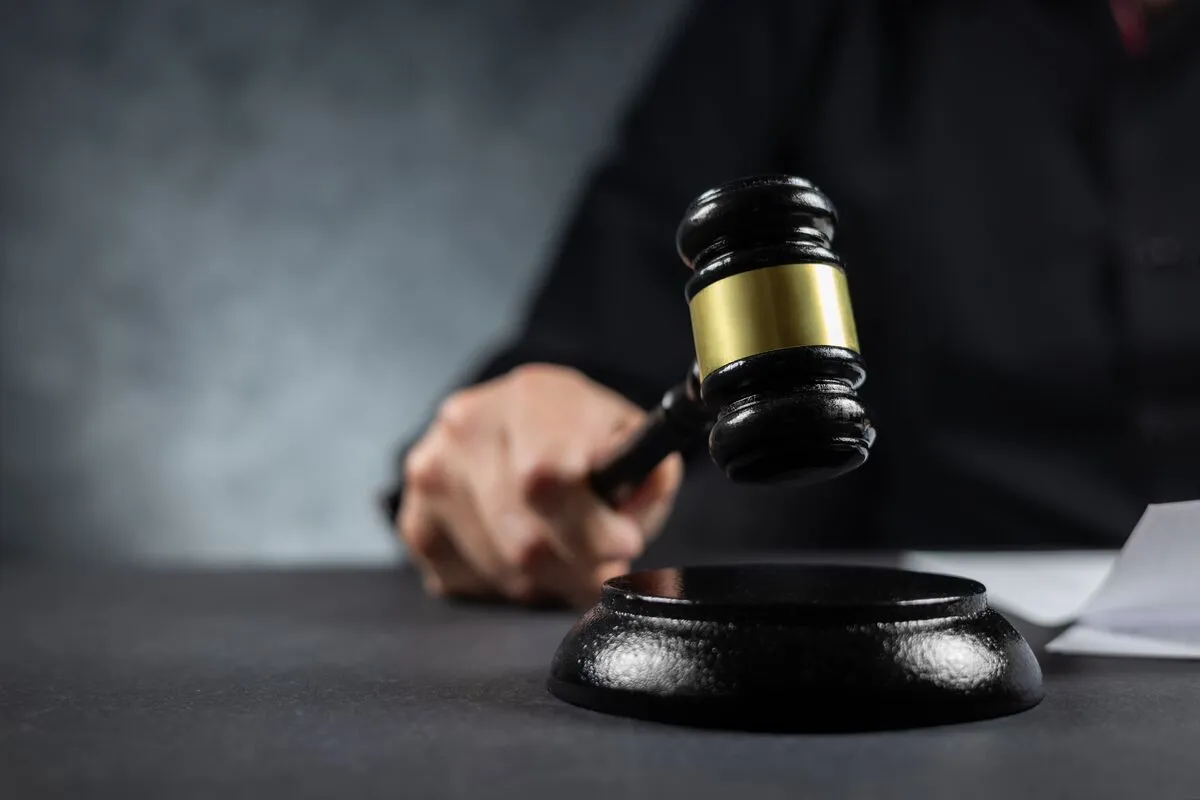 Judge's,Gavel,In,Hand,Judges,Is,Placed,On,A,Table