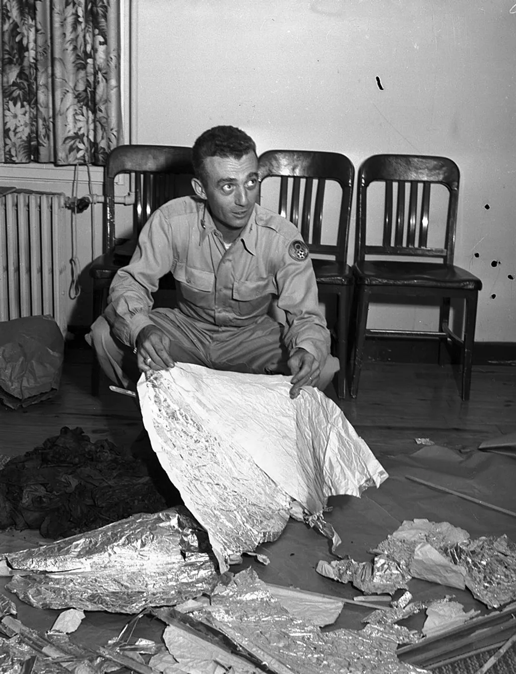 At Fort Worth Army Air Field, Major Jesse A. Marcel (looking left) of Houma, LA - holding foil debris from Roswell, New Mexico, UFO incident, 07/08/1947